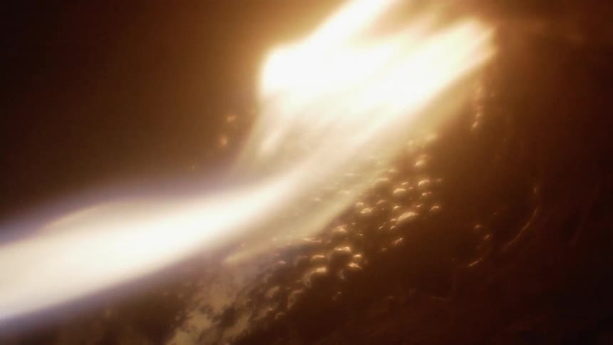 A fire burns a bubbling piece of rock