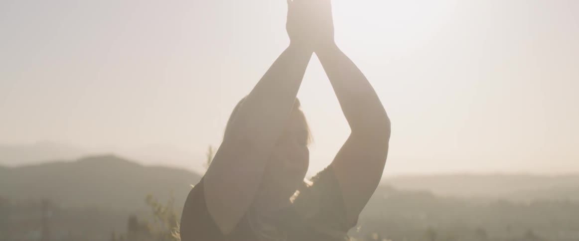 Woman doing yoga on a sunny day