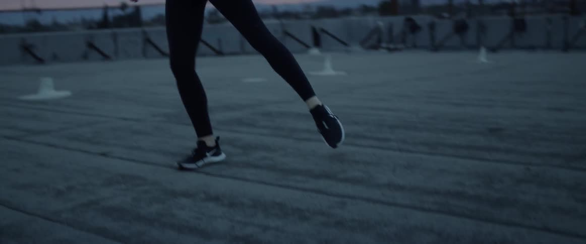 A white dancer dips and swoops on top of a room at sunset