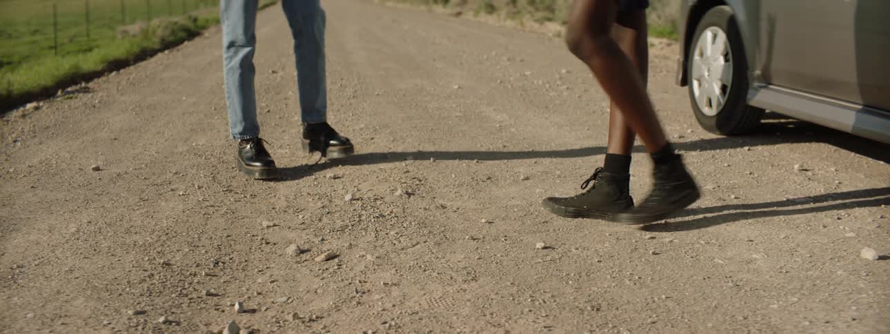 Two women walking around on a dirt road
