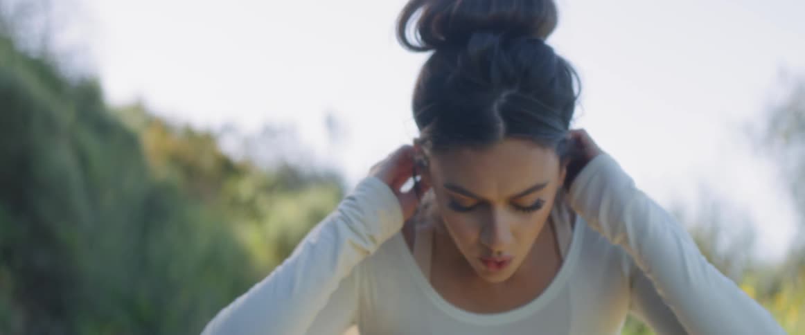 A woman stops to catch her breath outside