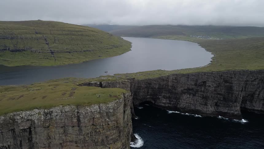 We move over tall cliffs that have water at their base and their top