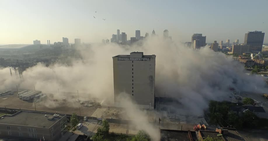 An aerial view of smoke billowing from a fire in a city