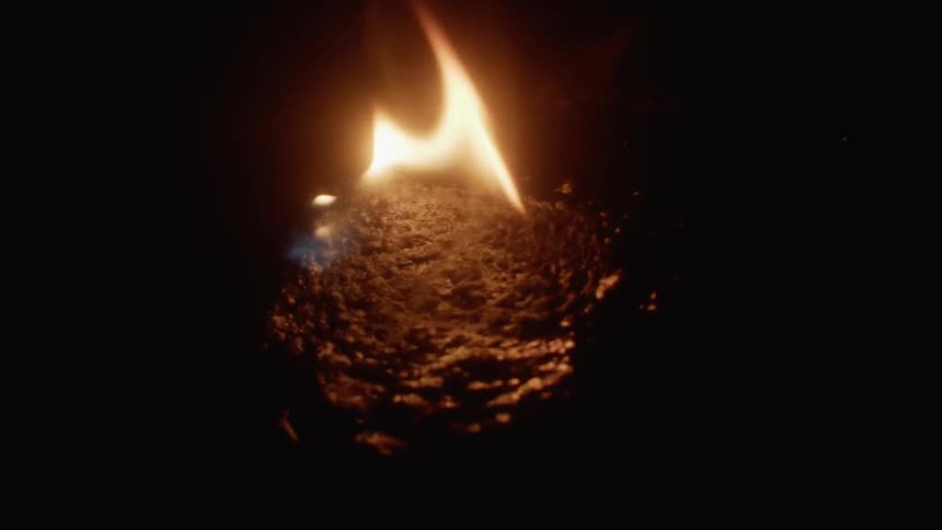 Fire burns on a rock