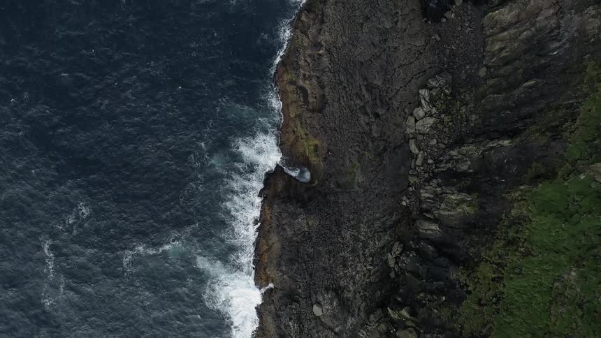 Aerial view of steep cliffs and rocks overlooking the ocean