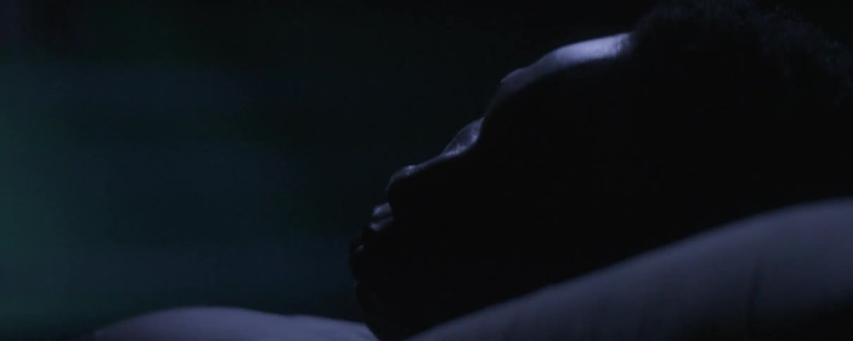 A man laying outdoors and sleeping at night