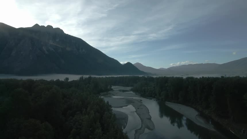 Mountains loom over a reflective body of water