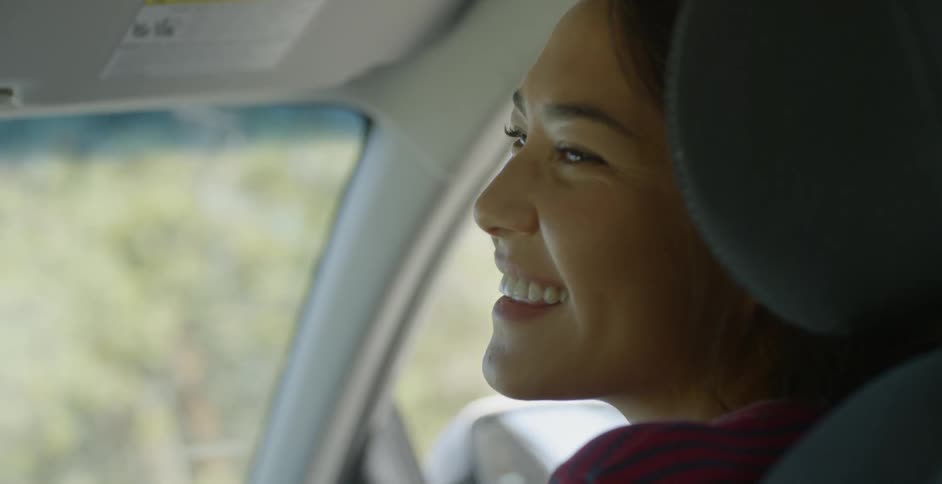 A female vehicle passenger looking very happy