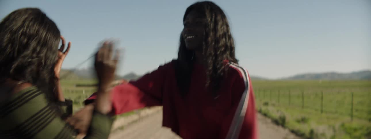 Two women fight and push each other in the country