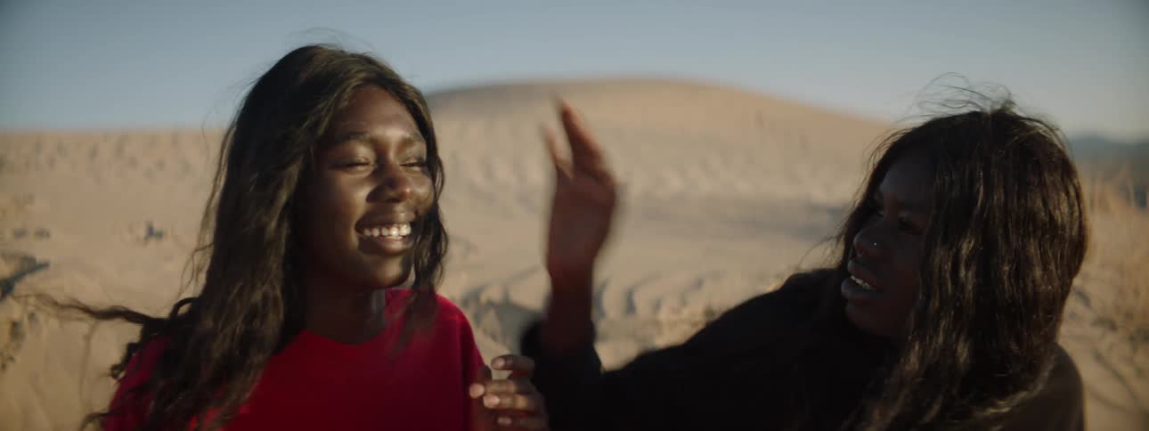 Two women standing in the desert