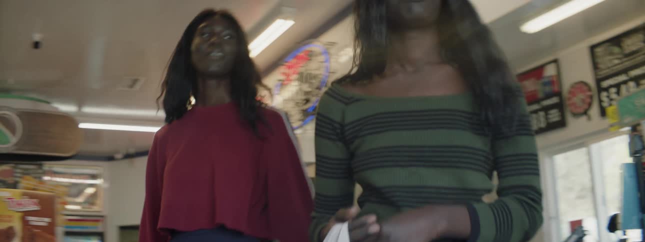 Two women order food and carry it out of the restaurant