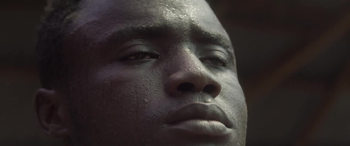 Man covered in sweat stares in the distance
