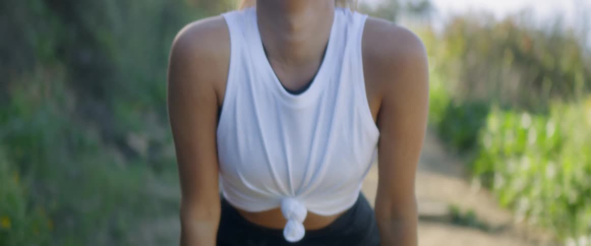 A woman stretches and breathes deeply at sunrise