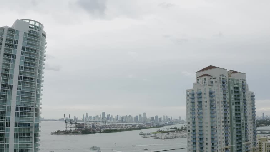A view of tall buildings in a city that is by the ocean