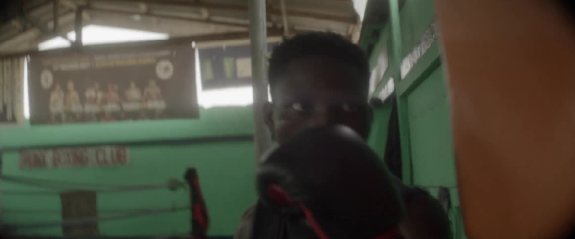 A man fiercely hitting a punching bag