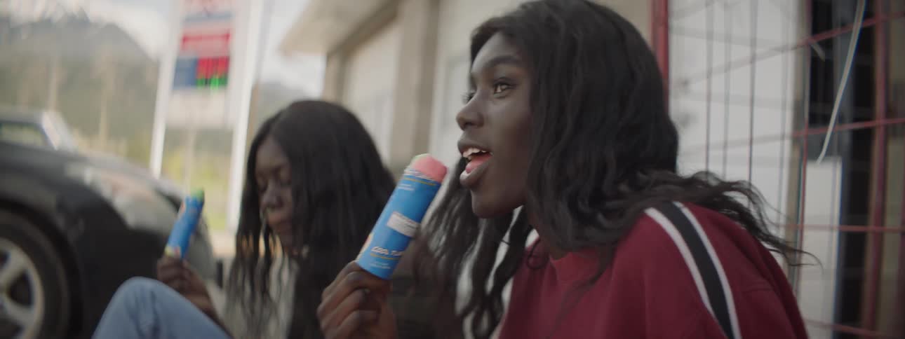 Two woman eat frozen push pops