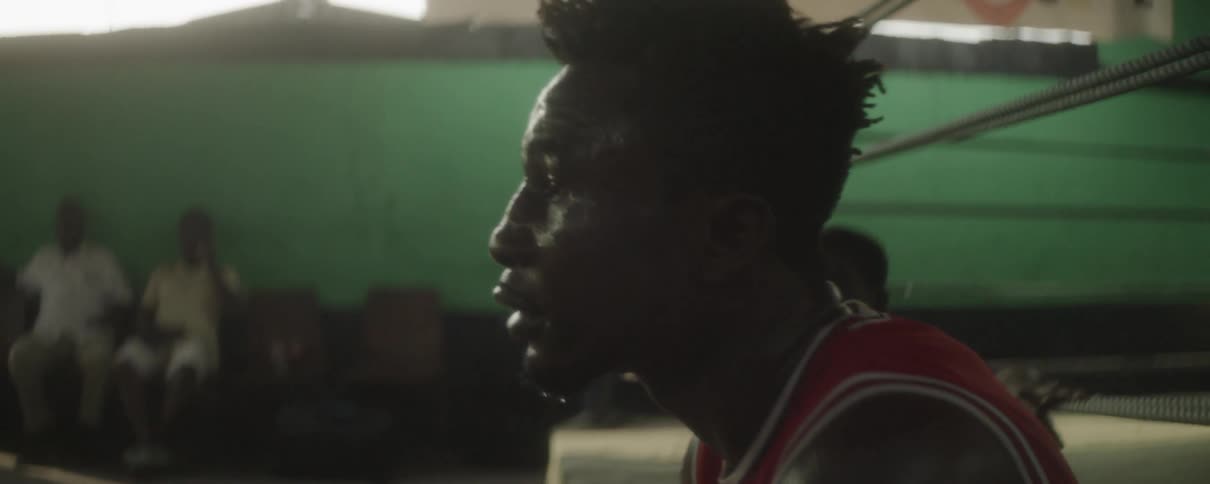 A man getting up from sitting around in a gym