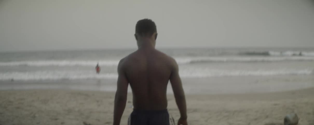 A man walks down the beach toward the water