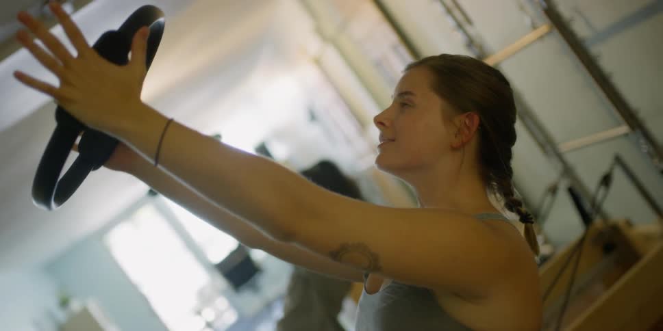 Two women that are holding weights over their head