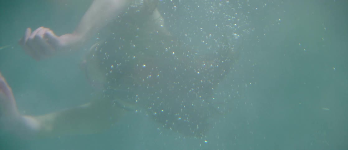 A woman swims under water