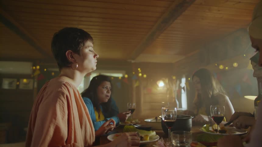 A group of women sitting around a table having a meal