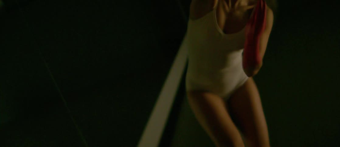 A woman that is dancing around in front of a mirror