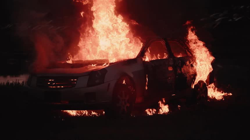 A car is on fire at night