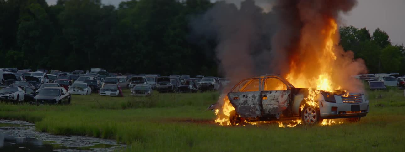 Firemen Extinguishing Burning Car