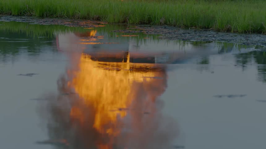 A fire that is burning on top of a lake