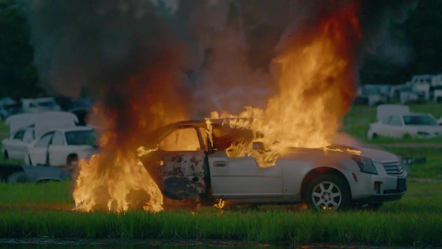 Firemen Extinguishing Burning Car