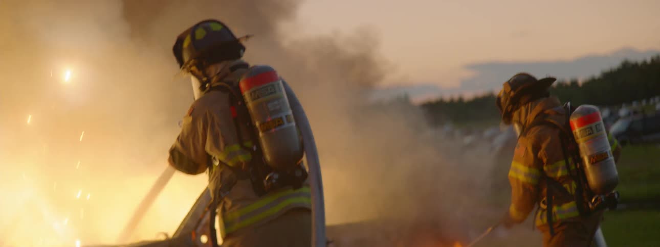 Firemen Extinguishing Burning Car
