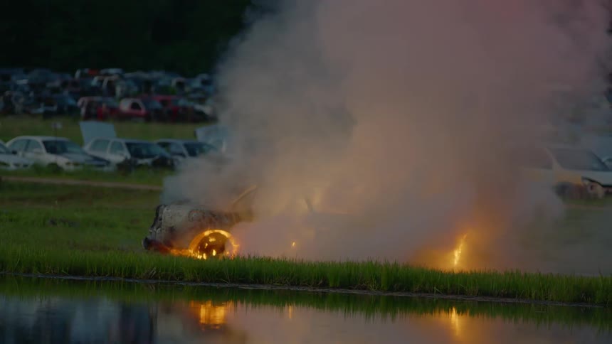 Firemen Extinguishing Burning Car