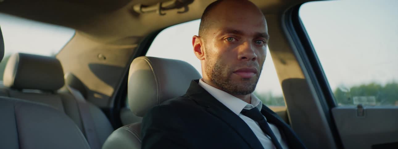 Suited Man Setting Car On Fire