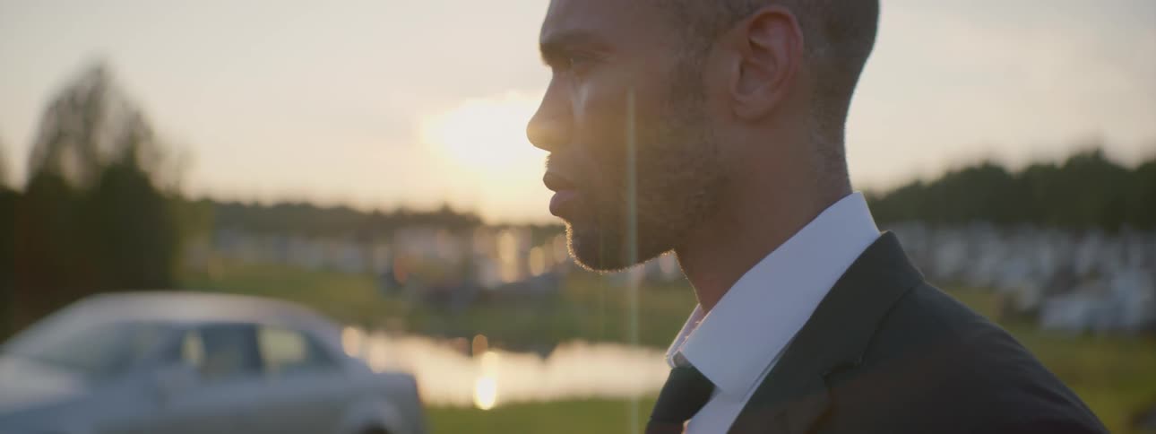 A man stares to the distance and turns his head
