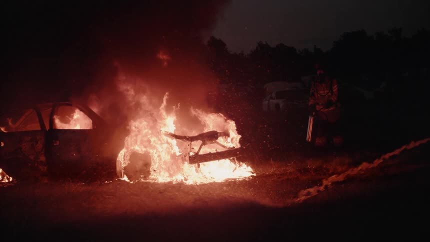 Firemen Extinguishing Burning Car