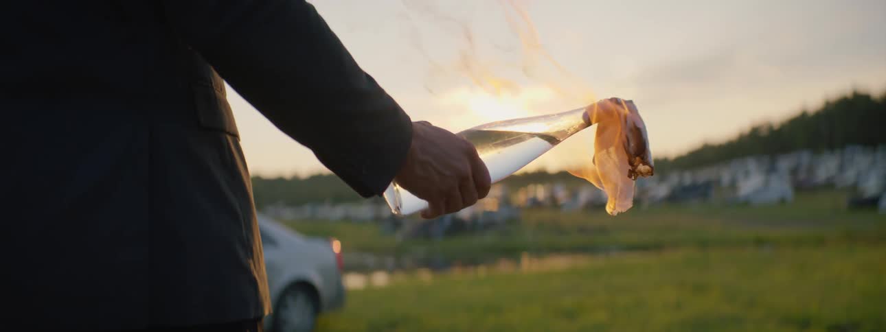 Suited Man Setting Car On Fire