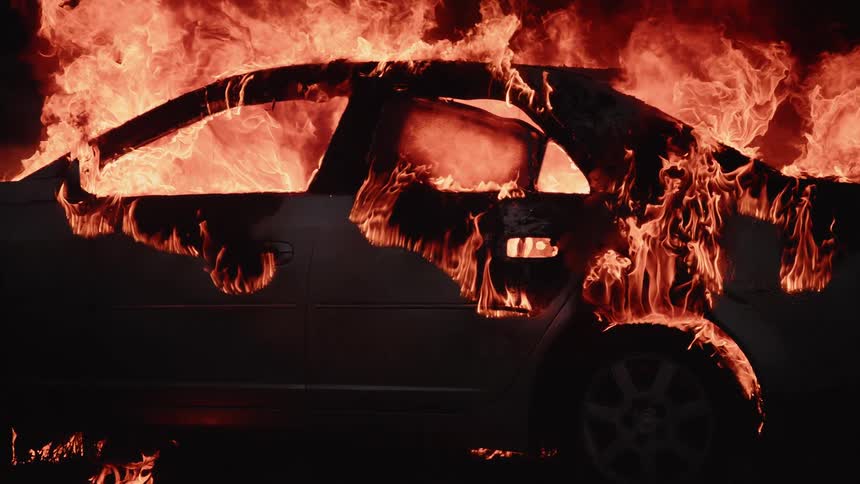 Firemen Extinguishing Burning Car