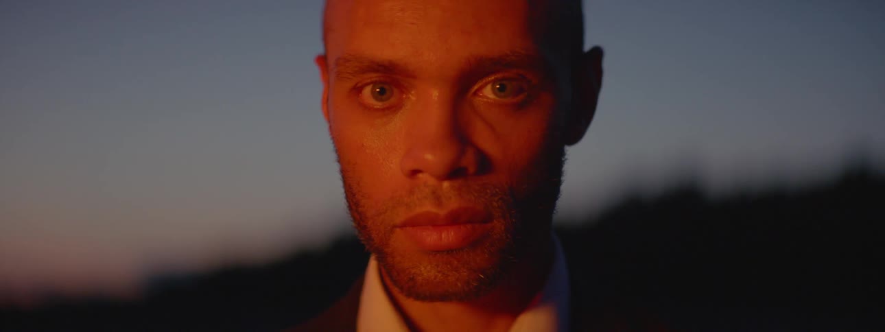 A man looking over his shoulder and then turning straight ahead