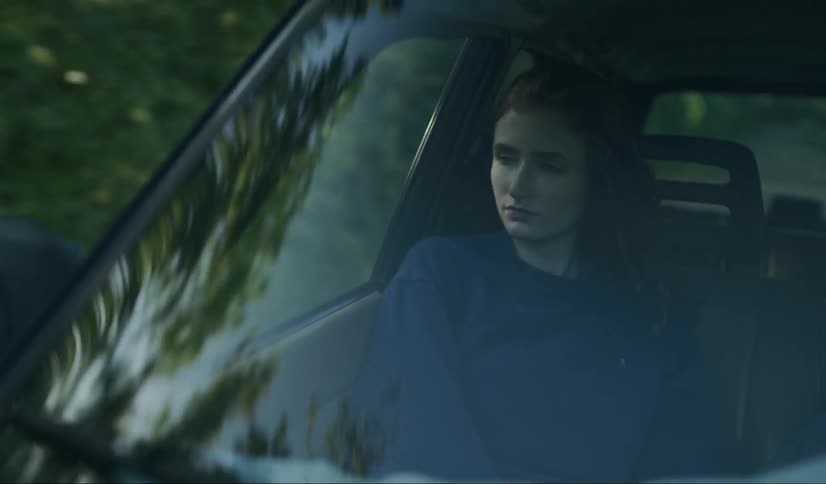 A woman passenger staring out of the vehicle