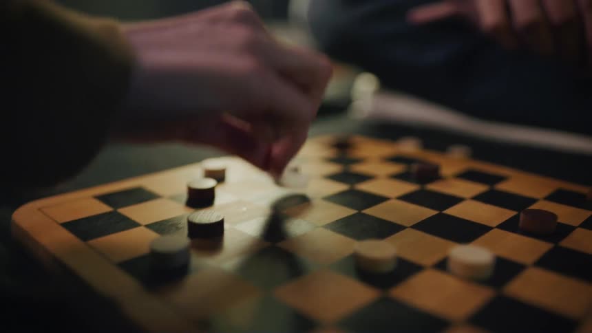 Two people that are playing checkers against each other