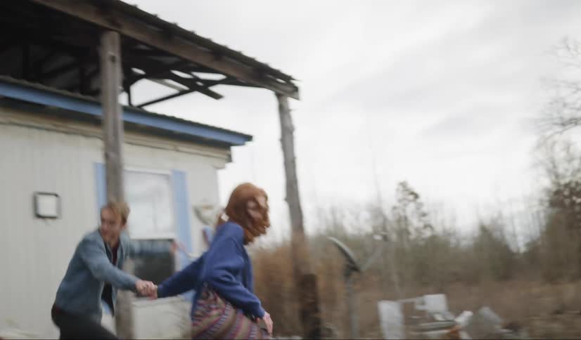 A man and a woman run out of the house toward a car