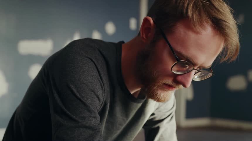 Man looks down at work station