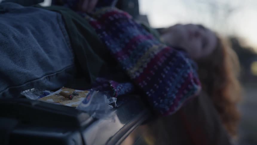 A woman laying around outside on a cloudy day