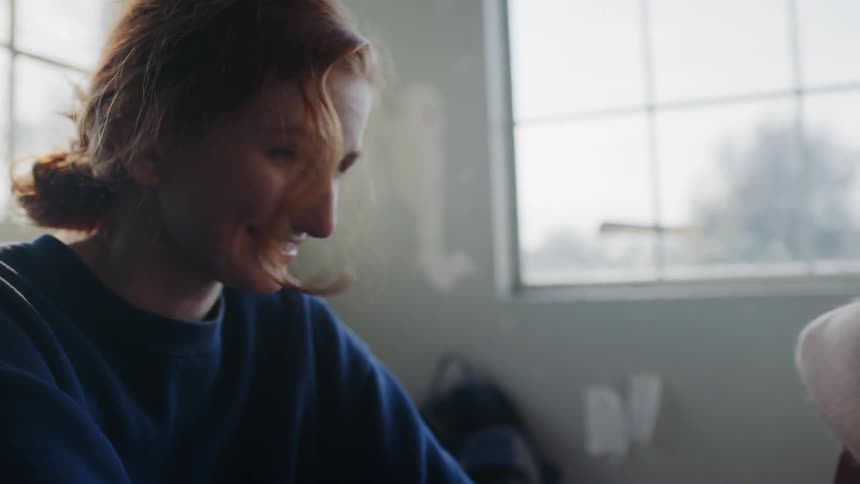 A woman laughing and shaking her head