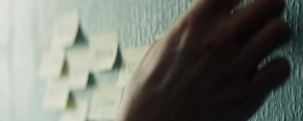A lot of sticky notes that are being placed on a board