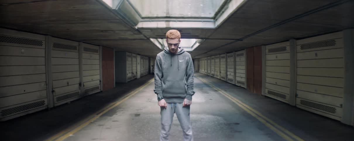 A man standing in the middle of a street looking angry