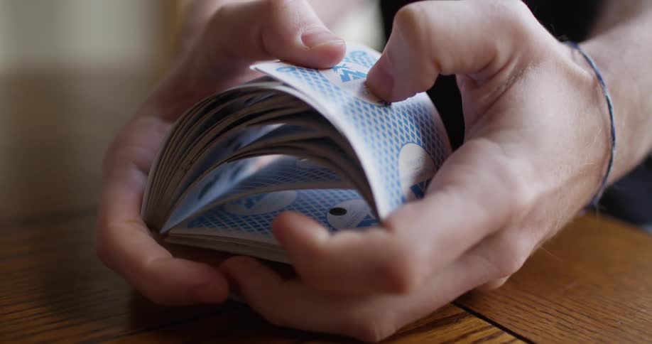 A person is shuffling a deck of cards