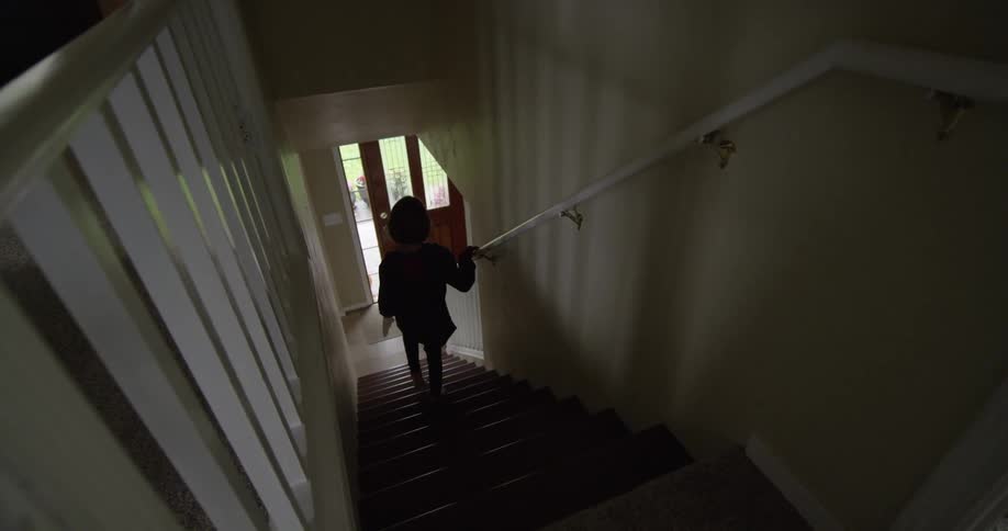 A girl descends household stairs