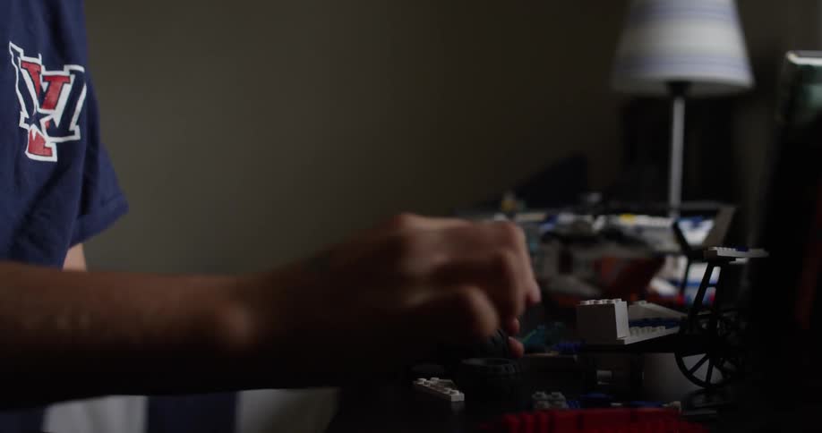 A boy plays with his toys