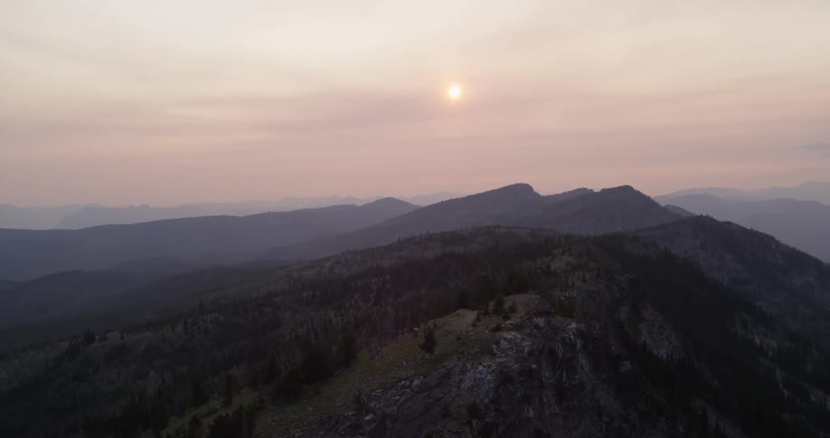 The sun is setting over a mountain